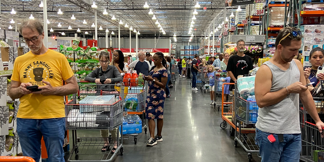 Customers wait in long lines at a Costco in Orlando, Florida on Friday, September 23, 2022, ahead of Tropical Storm Ian.