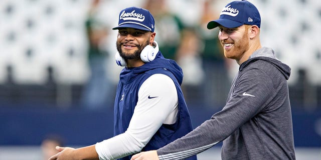 Dak Prescott, left, and Cooper Rush of the Dallas Cowboys warm up before a game against the Green Bay Packers at AT and T Stadium on Oct. 6, 2019, in Arlington, Texas.