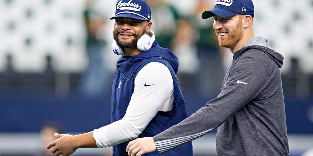 Dak Prescott, left, and Cooper Rush of the Dallas Cowboys warm up before a game against the Green Bay Packers at AT and T Stadium on Oct. 6, 2019, in Arlington, Texas.