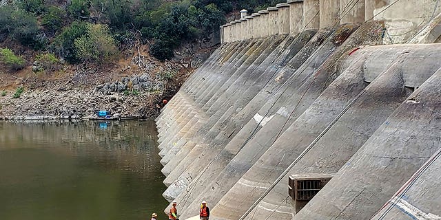Pictured: A photo of workers repairing the 104-year-old Hodges Reservoir Dam in San Diego, California, on Sept. 12, 2022.