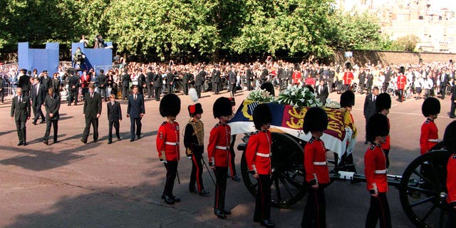 The Princess of Wales' coffin, escorted by Coldstream Guards, in The Mall on the day of her funeral service.