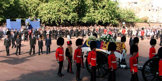 The Princess of Wales' coffin, escorted by Coldstream Guards, in The Mall on the day of her funeral service.