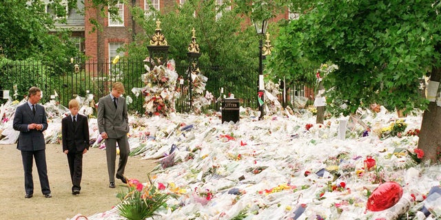 Prince William and Prince Harry look at flowers left by thousands of mourners following the death of Princess Diana in 1997.