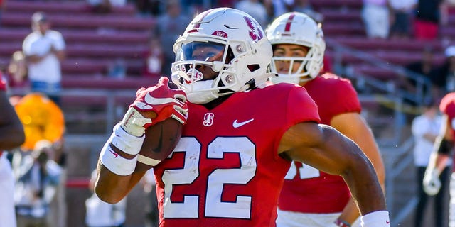 Stanford Cardinal running back E.J. Smith (22) gets accompaniment from teammates downfield on his 84-yard TD in the first 18 seconds of the game between the Colgate Raiders and the Stanford Cardinal on Saturday, Sept. 3, 2022 at Stanford Stadium in Palo Alto, California.