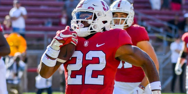 Stanford Cardinal running back E.J. Smith (22) gets accompaniment from teammates downfield on his 84-yard TD in the first 18 seconds of the game between the Colgate Raiders and the Stanford Cardinal on Saturday, Sept. 3, 2022 at Stanford Stadium in Palo Alto, California.