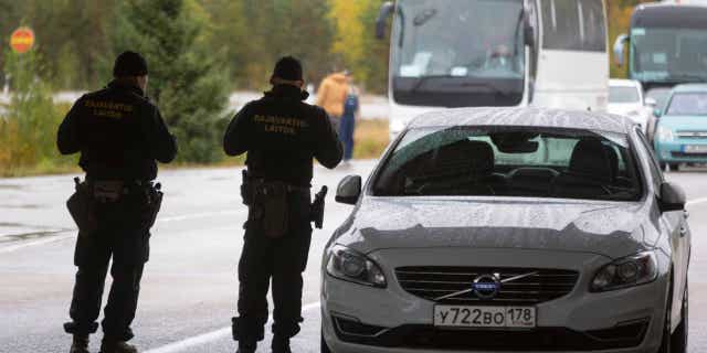 Finnish border agents guard the Russian border in Virolahti, Finland, on Sept. 30, 2022, amid an EU crackdown on visas for Russian citizens.