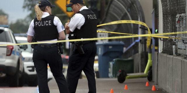 Chicago police officers guard a crime scene after a shooting at the CTA Red Line station at 79th Street on Aug. 8, 2022.