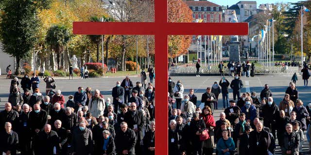 The French Catholic Church has already paid reparations to 23 individuals who suffered sexual abuse as children by members of the French Catholic Church. Pictured: Bishops kneel out front of the Notre-Dame-du-Rosaire basilica in Lourdes, southwestern France, on Nov. 6, 2021.