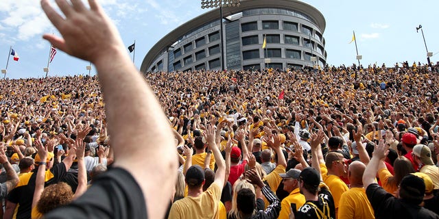 Fans wave to children at the University of Iowa Stead Family Children's Hospital during the first half of a matchup between the Iowa Hawkeyes and Rutgers Scarlet Knights Sept. 7, 2019, at Kinnick Stadium in Iowa City, Iowa. 