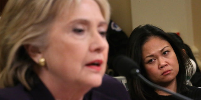 Dorothy Narvaez-Woods, widow of CIA contractor and former Navy SEAL Tyrone Woods, looks on as former Secretary of State Hillary Clinton testifies before the House Select Committee on Benghazi Oct. 22, 2015.