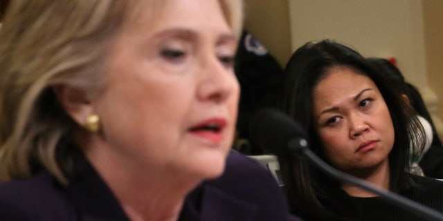 Dorothy Narvaez-Woods, widow of CIA contractor and former Navy SEAL Tyrone Woods, looks on as former Secretary of State Hillary Clinton testifies before the House Select Committee on Benghazi Oct. 22, 2015.