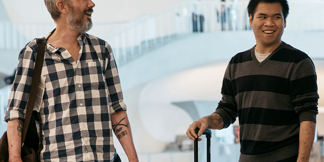 American's Andy Huynh, right, and Alex Drueke, left, chat as they arrive at the TWA Hotel on Friday, Sept. 23, 2022 in New York. The two U.S. military veterans who disappeared three months ago while fighting Russia with Ukrainian forces were among 10 prisoners, including five British nationals, released this week by Russian-backed separatists as part of a prisoner exchange mediated by Saudi Arabia. 