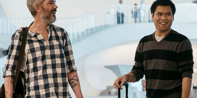 American's Andy Huynh, right, and Alex Drueke, left, chat as they arrive at the TWA Hotel on Friday, Sept. 23, 2022 in New York. The two U.S. military veterans who disappeared three months ago while fighting Russia with Ukrainian forces were among 10 prisoners, including five British nationals, released this week by Russian-backed separatists as part of a prisoner exchange mediated by Saudi Arabia.