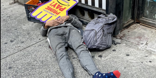On midday this past Monday, Sept. 12, 2022, a man slept on Eighth Avenue in Manhattan just one block from Times Square. His face was covered by an SEIU Local 1199 sign demanding "prime pay!" for workers.