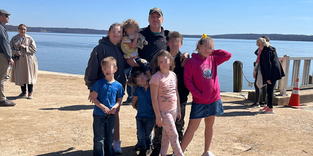 Mark Houck with his family near a beach