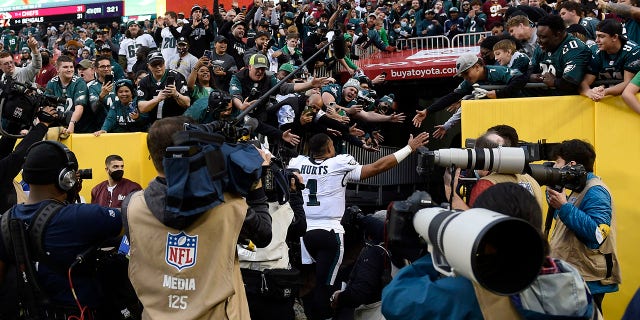 Jalen Hurts (1) of the Philadelphia Eagles celebrates with fans after their 20-16 win over the Washington football team at FedEx Field. January 2, 2022, in Landover, MD.