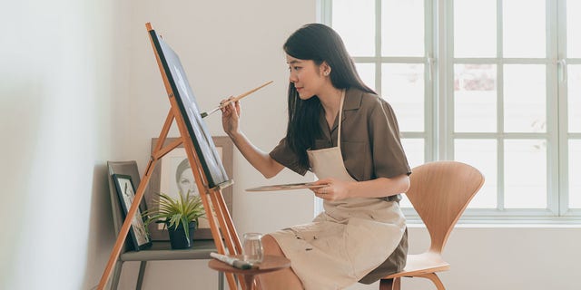 A woman creates art in her home studio. Hobbies that have no strings attached count as rest just as much as sitting and doing absolutely nothing at all, author Celeste Headlee suggested. ?