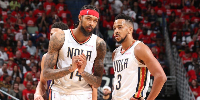 Brandon Ingram #14 and CJ McCollum #3 of the New Orleans Pelicans talk during Round 1 Game 6 of the 2022 NBA Playoffs against the Phoenix Suns on April 28, 2022 at the Smoothie King Center in New Orleans, Louisiana.