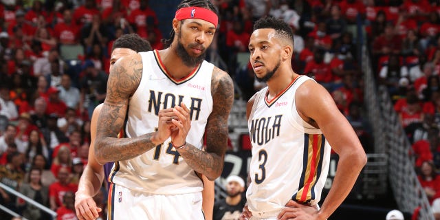 Brandon Ingram #14 and CJ McCollum #3 of the New Orleans Pelicans speak during Game 6 of the 2022 NBA Playoffs Round 1 against the Phoenix Suns on April 28, 2022 at the Smoothie King Center in New Orleans, Louisiana.