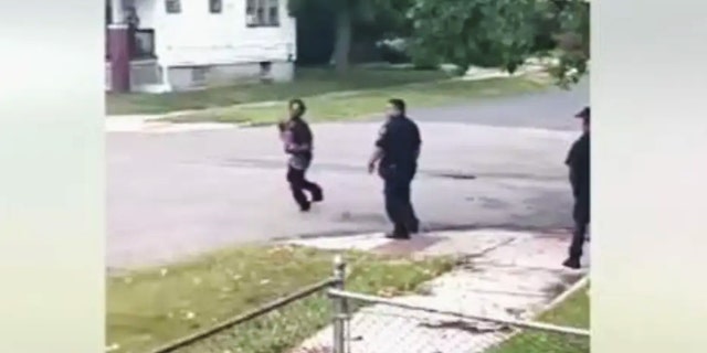 Maria Mariweather couldn't believe what she was seeing - a man ranting while carrying a baby and yelling at police officers on Detroit's west side.