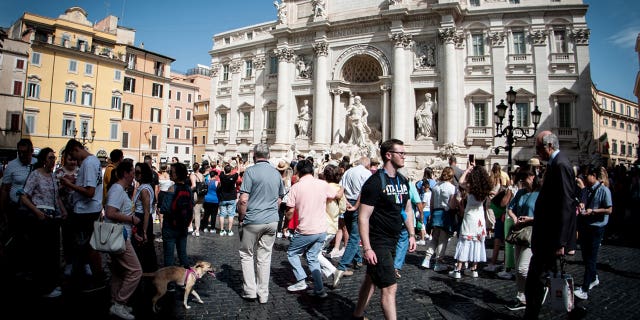 Italy may see a smaller population in the next 50 years, statistic agency ISTAT said. Pictured: A crowd in front of the Trevi Fountain square in Rome, Italy, on June 3, 2022.