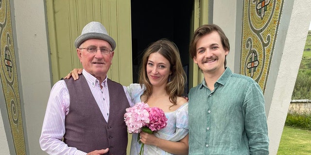 Jack Gleeson and Róisín O’Mahony post with Father Patsy Lynch outside of the church. 