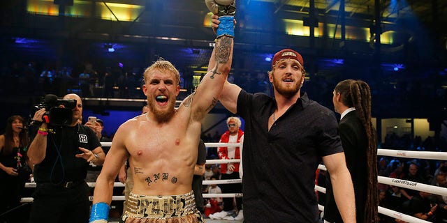 Jake Paul celebrates with his brother, Logan, after defeating AnEsonGib in a first round knockout during their fight at Meridian at Island Gardens on Jan. 30, 2020 in Miami, Florida.