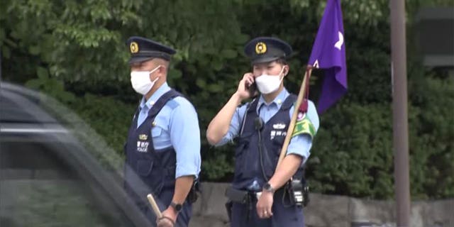 Pictured: Japanese policeman at a site where a man set himself on fire near the prime minister's office on Sept. 21, 2022.