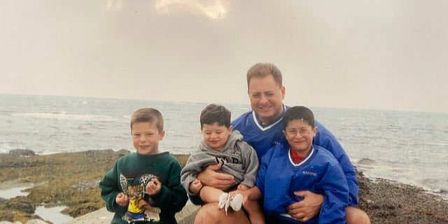 Matthew Bocchi wears the same jacket as his father and is pictured alongside his brothers Nick (left) and Michael (middle).