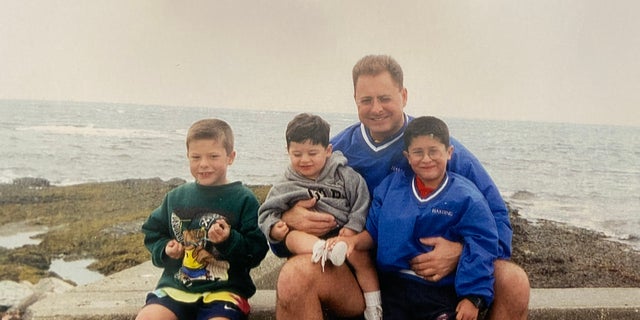 Matthew Bocchi wears a jacket matching his father's, pictured alongside his brothers Nick, left, and Michael, center.