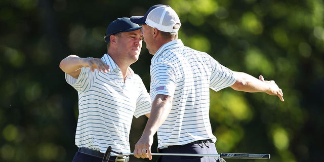 Justin Thomas, left, and Jordan Spieth of Team USA celebrate after winning 2-1 against Adam Scott and Cam Davis of Australia and Team International in Friday's Four-Ball matches of the United States Cup 2022 Presidents at Quail Hollow Country Club in Charlotte, North Carolina, Sept. 23, 2022.