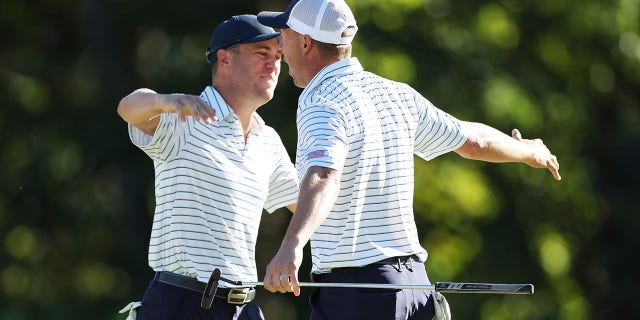 Justin Thomas, left, and Jordan Spieth of the United States Team celebrate after winning 2-and-1 over Adam Scott and Cam Davis of Australia and the International Team during Friday four-ball matches of the 2022 Presidents Cup at Quail Hollow Country Club in Charlotte, N.C., Sept. 23, 2022.