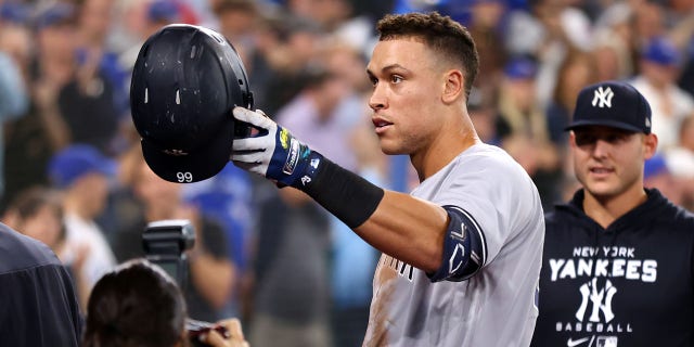 Aaron Judge #99 of the New York Yankees tips his hat towards his mother after hitting his 61st home run of the season in the seventh inning against the Toronto Blue Jays at Rogers Centre on September 28, 2022 in Toronto, Ontario, Canada. Judge has now tied Roger Maris for the American League record.