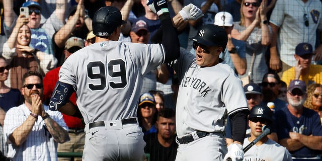 Anthony Rizzo of the New York Yankees congratulates Aaron Judge (99) after Judge's second home run of the game during the seventh inning against the Milwaukee Brewers at American Family Field in Milwaukee on Sept. 18, 2022.