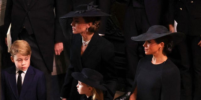 Catherine, Princess of Wales, Meghan, Duchess of Sussex, Prince George and Princess Charlotte arrive for the state funeral of Queen Elizabeth II at Westminster Abbey on Sept.  19, 2022.