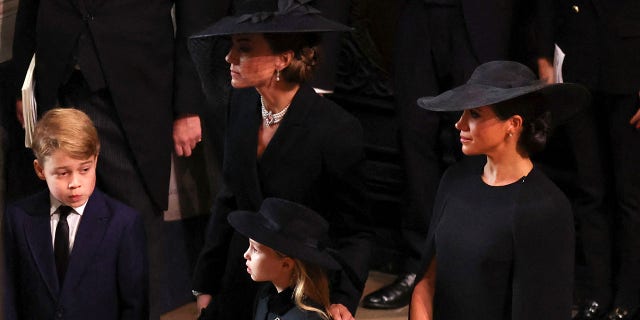 Catherine, Princess of Wales, Meghan, Duchess of Sussex, Prince George and Princess Charlotte arrive to the State Funeral of Queen Elizabeth II, held at Westminster Abbey on Sept. 19, 2022, in London.  