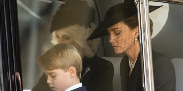 Prince George, Camilla, Queen Consort, and Catherine, Princess of Wales, are shown during the state funeral of Queen Elizabeth II.