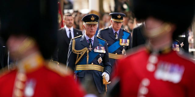 King Charles follows the coffin of Queen Elizabeth II during a procession from Buckingham Palace to Westminster Hall.