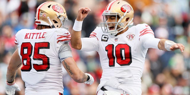 Jimmy Garoppolo (10) of the San Francisco 49ers celebrates after throwing a touchdown pass to George Kittle (85) during the second quarter against the Seattle Seahawks at Lumen Field Dec. 5, 2021 in Seattle.