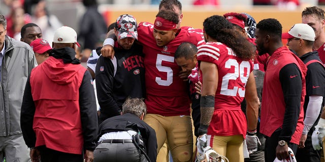 San Francisco 49ers quarterback Trey Lance (5) is helped onto a dolly during the first half of an NFL football game against the Seattle Seahawks in Santa Clara, Calif. on Sunday, September 18, 2022.