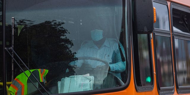 A bus driver wears a mask in Downtown Los Angeles on March 22, 2020, during the coronavirus (COVID-19) outbreak.
