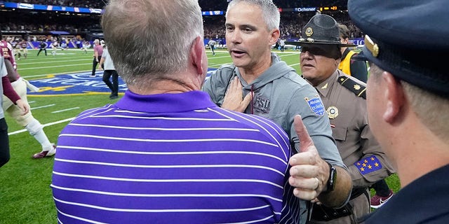 Florida State University head coach Mike Nobel greets LSU head coach Brian Kelly after the NCAA college football game in New Orleans on Sunday, September 4, 2022. Florida State won him 24-23.