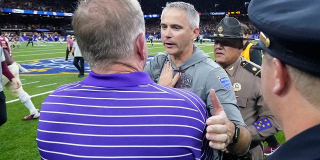 Florida State head coach Mike Norvell, facing, greets LSU head coach Brian Kelly after their NCAA college football game in New Orleans, Sunday, Sept. 4, 2022. Florida State won 24-23.