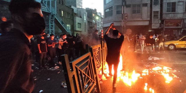 People light a fire during a protest in Tehran, Iran Sept, 21, 2022.