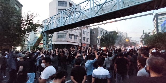 People attend a protest over the death of Mahsa Amini, a woman who died after being arrested by the Islamic republic's "morality police", in Tehran, Iran September 21, 2022. 
