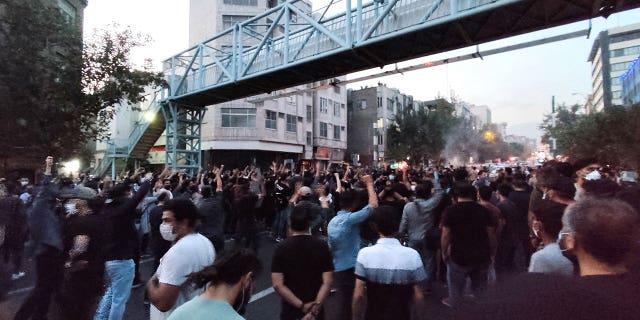 People take part in a protest against the death of Masa Amini, a woman who died after being arrested by the Islamic Republic's moral police on September 21, 2022 in Tehran, Iran. 