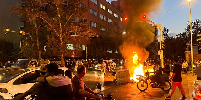 A police motorcycle is on fire during a protest against the death of a Masa Amini woman who died after being arrested by the Islamic Republic. "moral police"19 September 2022 in Tehran, Iran. 