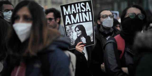 Protesters in Berlin, Germany, protest the death of Mahsa Amini on Sept. 28, 2022, after she died in police custody in Iran for wearing her hijab too loosely.