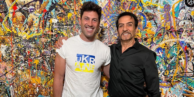 Davood Roostaei and Maksim Chmerkovskiy in front of Roostaei’s painting, "Imagine — 2022."