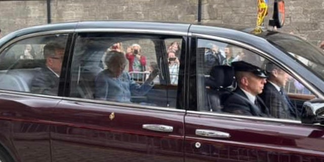Mary Anne Donaghy, an American tourist from the Boston area, took this photo of the Queen walking past her car in Scotland this summer. "Today we all have a loss," Donaghy told Fox News Digital. "His character comes only once in a generation - he devoted his whole life to service."